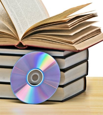 Pile of books  and DVD disk as symbols of old and new methods of information storage