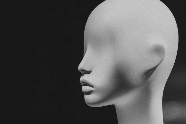 Black and white image of an eyeless mannequin.