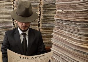 retro man reading newspaper in newspaper storage room