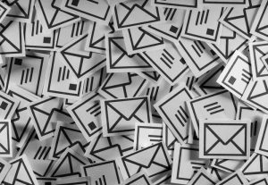 Stylized illustration of part of a huge pile of envelopes.