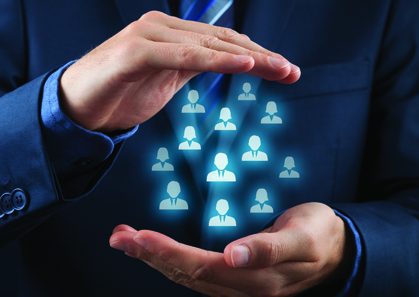 Constructed Illustration showing, in front view, a guy with suit holding within his cupped hands icon representations of human figures, presumptively "employees."