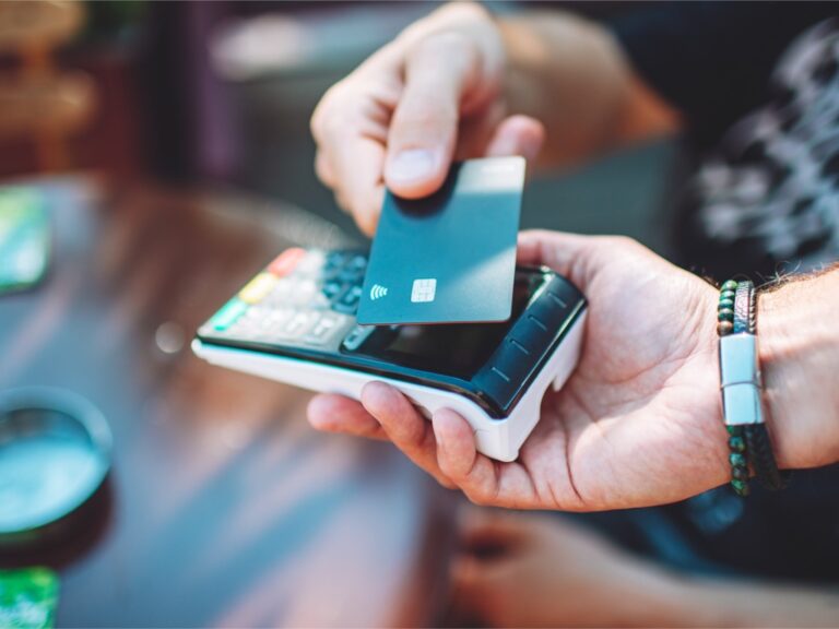 adult-man-paying-with-credit-card-at-cafe-close-up-of-hands-with-credit-card-and-credit-card