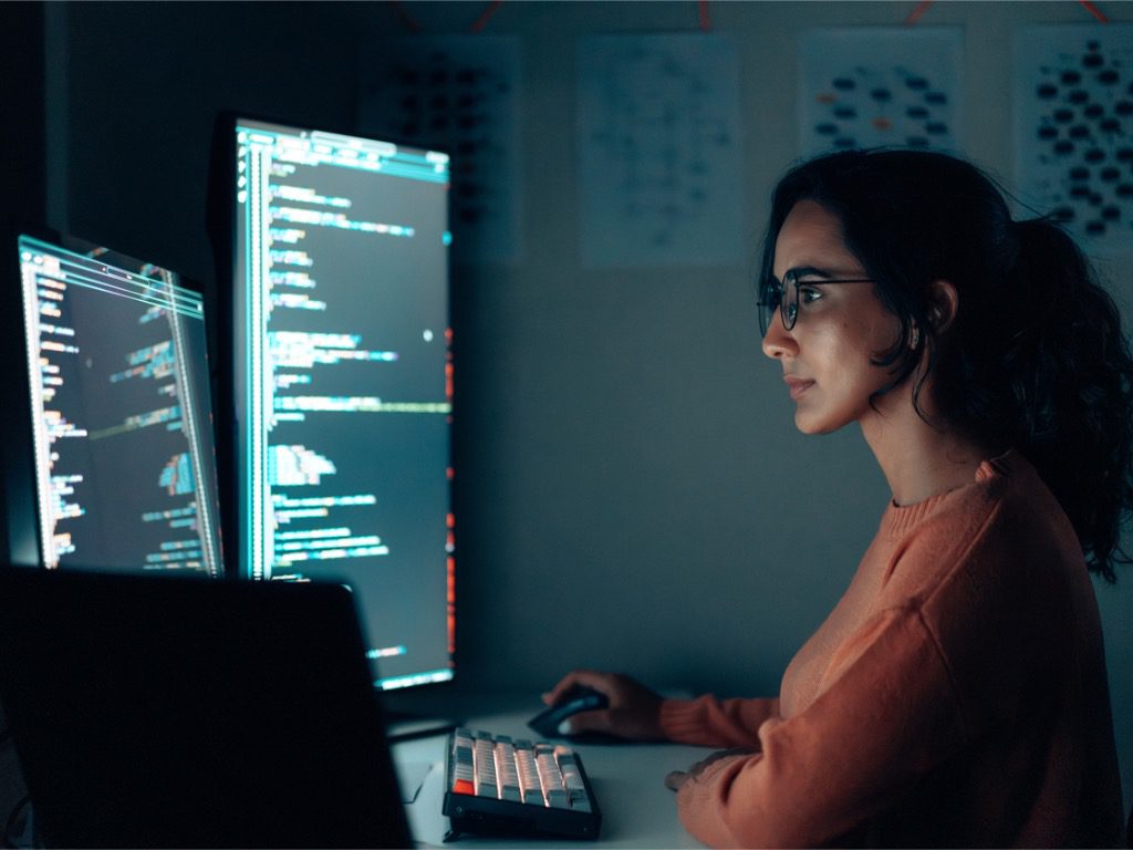 hispanic-latin-female-programmer-coding-at-night-in-a-high-tech ...
