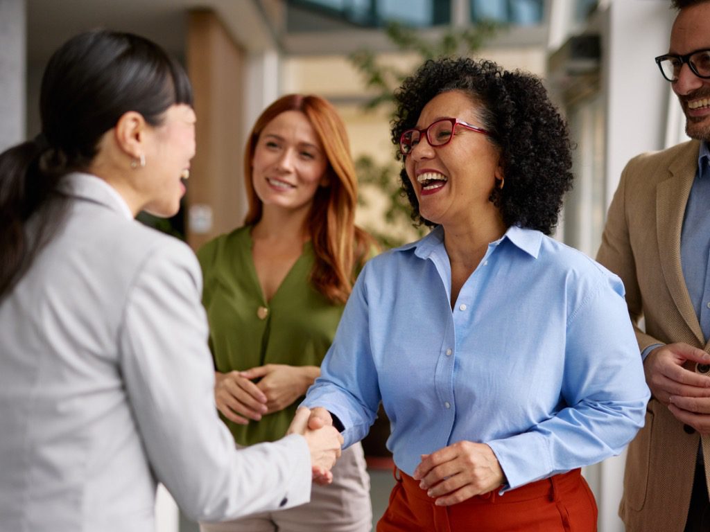 diverse business colleagues shaking hands