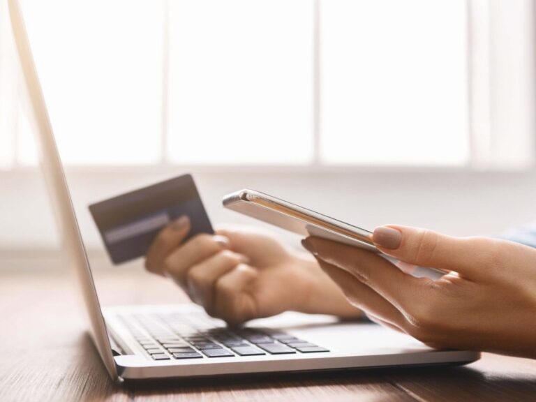 young businesswoman booking tickets online with credit card