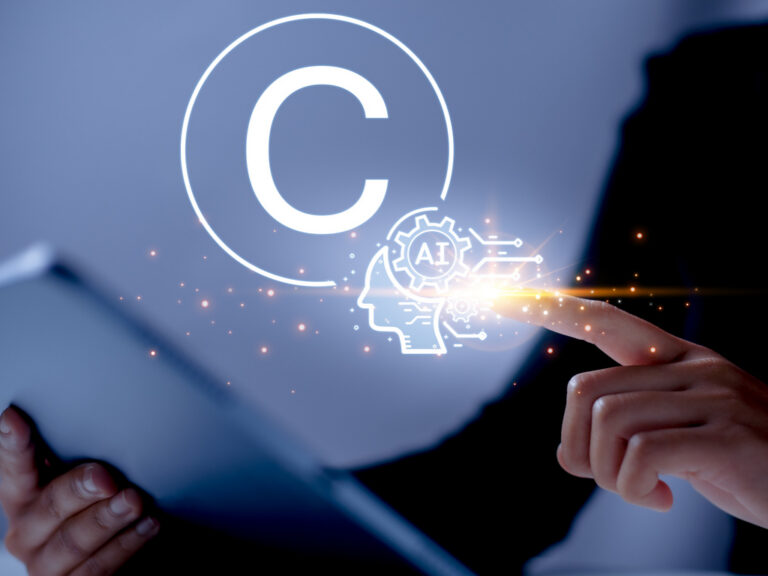Finger touches a glowing holographic AI head icon next to a large copyright symbol, conveying AI copyright concepts.
